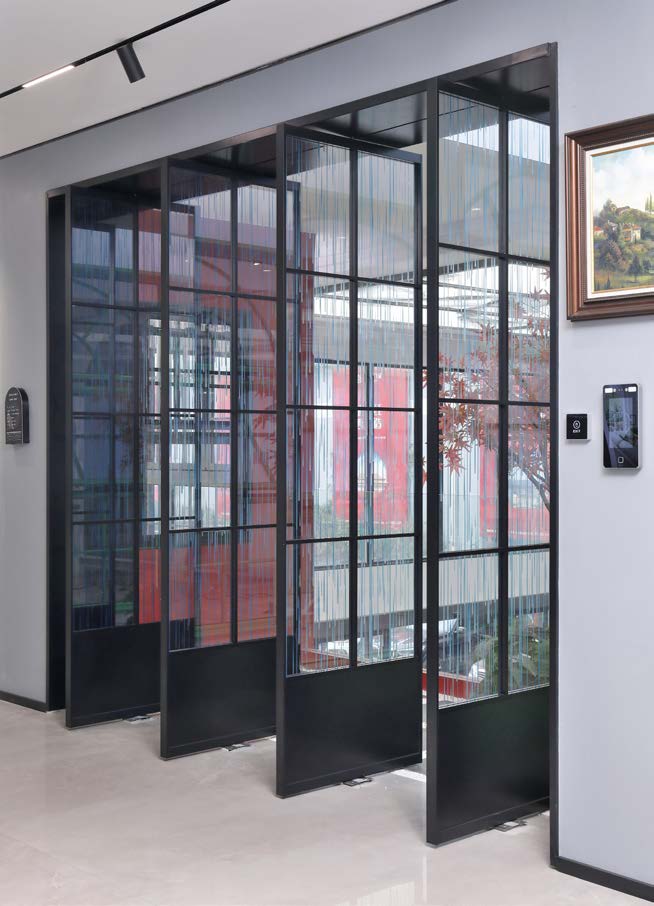 Motorized interior aluminum pivot door opening on its own with a concealed motor.