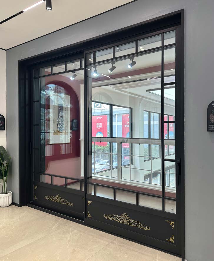 Interior aluminum sliding door with slim black frames dividing two rooms.
